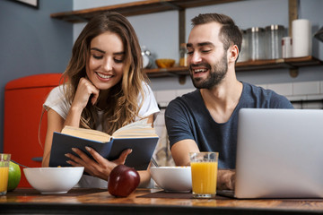 Wall Mural - Beautiful cheerful couple having breakfast