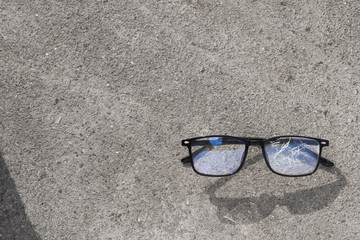 Wall Mural - broken glasses lying on the street asphalt