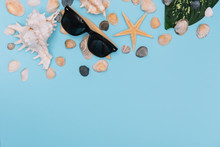 Beach Accessories. Towel, Flip-flops, Starfish, Boat And Sunglasses On Wooden Background. Top View With Copy Space. Sunny Toned