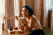 © DragonImages - Happy woman eating breakfast