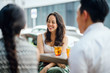 © Danon - A beautiful image of a diverse team enjoying their cocktails while sitting and chatting outdoors. They are all smiling and seems to be having a good time.