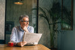 © cherryandbees - relaxing morning time in cafe bar. man reading newspaper and drinking coffee