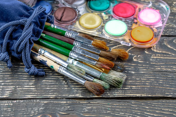 Paint brushes and paints for drawing.