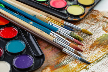 Paint brushes and paints for drawing.