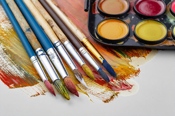 Paint brushes and paints for drawing.