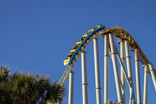 Rollercoaster Dropping Down At Amusement Park