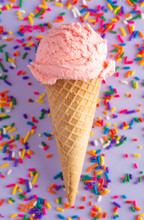 Scoop Of Strawberry Ice Cream In A Waffle Cone