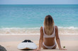 © South House Studio - nice back view of wonderful girl sitting on pink sand beach with her surf board