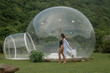 © South House Studio - slim girl in glasses and capote having fun outdoors near inflatable bubble tent