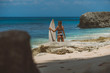 © South House Studio - girl holding surfboard and watching ocean, magnificent views of pink sand beach