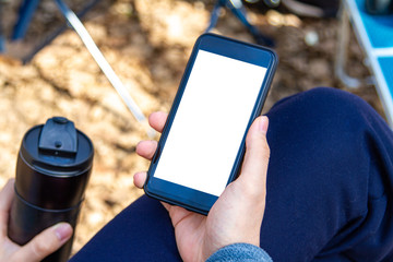 Hand Holding Phone with White Blank Screen Outdoor