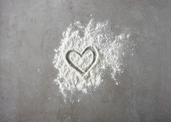 heart shape in flour on grey kitchen table