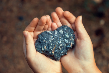 Asphalt Heart Shaped Shape in Kid Hands