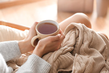 Young Woman Drinking Hot Tea At Home, Closeup