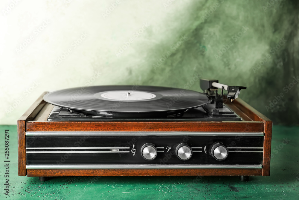 Record player with vinyl disc on table