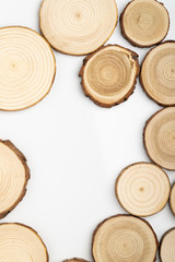 Wall Mural - Pine tree cross-sections with annual rings on white background. Lumber piece close-up shot, top view.