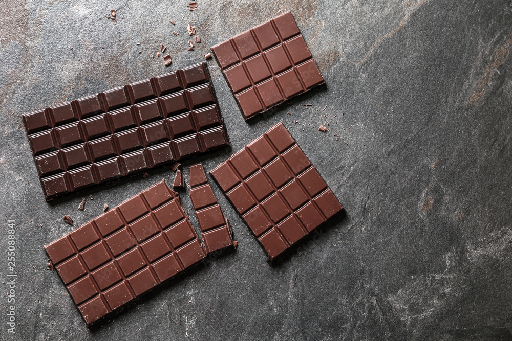 Sweet tasty chocolate on grey background