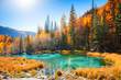 Geyser lake with turquoise water in autumn Altai mountains, Siberia, Russia.