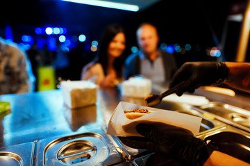 Serving street food at night at festival