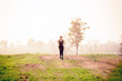 © Sirirat Makprasert - Runner athlete running at green area.Young woman doing yoga exercise yoga master pose Amazing yoga landscape in beautiful and enjoying view, fitness silhouette sunrise jogging workout wellness concept