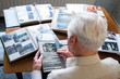 Top view of a senior man looking through old photo albums themes of memories nostalgia photos retired