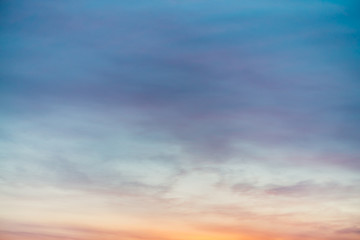 Wall Mural - sunset sky with violet yellow light clouds. colorful smooth blue sky gradient. natural background of