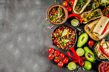 Wall Mural - Cinco de Mayo food.Mexican food concept background with taco, quesadilla, burrito, chili, salsa sauce, hot pepper, lime. Black concrete background top view copy space