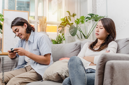 Young Woman Look At Her Boyfriend From Behind Who Ignore And