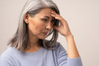 © Svyatoslav Lypynskyy - Mature Asian woman touches her forehead in distress