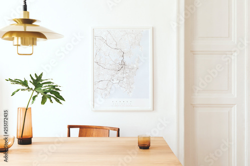Fotomural Stylish and modern dining room interior with mock up poster map, sharing table design chairs, gold pedant lamp and cups of coffee