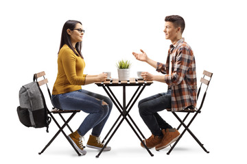 male and female student having a coffee and talking in a cafe