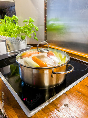Chicken Soup Cooking In A Pot On Ceramic Glas Cooktop Buy This