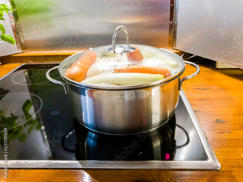 Chicken Soup Cooking In A Pot On Ceramic Glas Cooktop Buy This