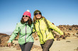 © simona - Happy cheerful couple of middle age women friends walking together at the mountain for alternative vacation - sunny day in outdoor leisure activity in the nature - happiness joyful lifestyle people