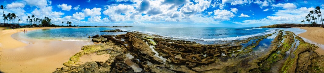 pano of beach with rocks and sand on left