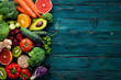 Healthy organic food on a blue wooden background. Vegetables and fruits. Top view. Free copy space.