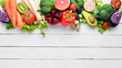 Fresh vegetables and fruits on a white wooden background. Healthy Organic Food. Top view. Free copy space.