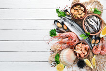 Seafood On A White Wooden Background. Fresh Fish, Shrimp, Oysters And Caviar. Top View. Free Copy Space.