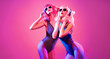 © evgenij918 - Fashion, neon. Glamour party fitness woman in trendy headphones dance. Two sexy slim DJ girl friend with Dyed Hair in colorful neon light. Beautiful fashionable model enjoy dancing. Creative art