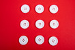 © Mitch Shark - nine white buttons on a red background