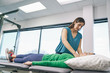 © Inti St. Clair - Physiotherapist giving shoulder massage to a woman in clinic