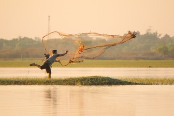 NAKHON PHANOM, THAILAND - Nov 4, 2018 : Fisherman casting a net into the lake