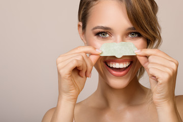 happy woman using nose applicator mask.
