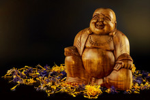 Wooden Buddha Statue Decorated With Flowers