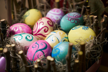 Colorful Easter eggs in a wooden nest decoration background