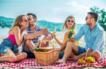 Wall Mural - Group of friends having fun on the beach. Lifestyle, vacation concept