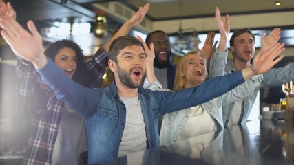 Wall Mural - Excited sport fans clapping hands in bar, cheering team, celebrating victory