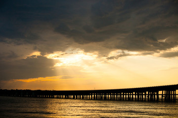 Wall Mural - Destin Florida Sunset over a Bridge Pier wth Rays of Light