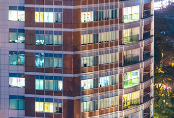 Wall Mural - Apartment windows in the night time.  Big city living in highrise urban environment.  Real estate concept.