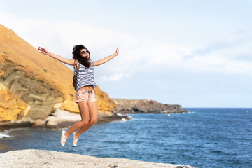 Wall Mural - Pretty tourist brunette girl having fun outdoor near sea.